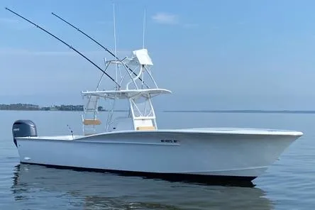  Yacht Photos Pics Custom Carolina Forbes 2025 boat on calm water with fishing rods and clear sky.