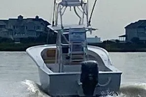  Yacht Photos Pics Custom Carolina Forbes 2025 boat cruising on water near coastal homes.