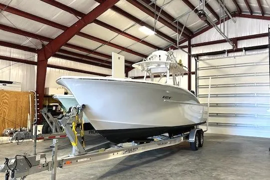  Yacht Photos Pics 2025 Custom Carolina Forbes boat on trailer in spacious indoor storage facility.