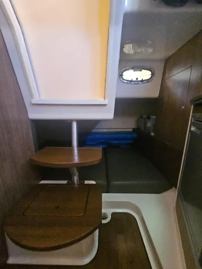  Yacht Photos Pics 2013 Boston Whaler 315 Conquest cabin interior with wooden steps and seating area.