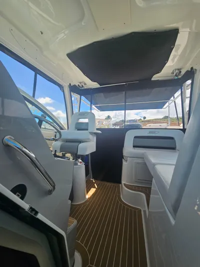  Yacht Photos Pics Interior view of 2013 Boston Whaler 315 Conquest boat with seating and helm.