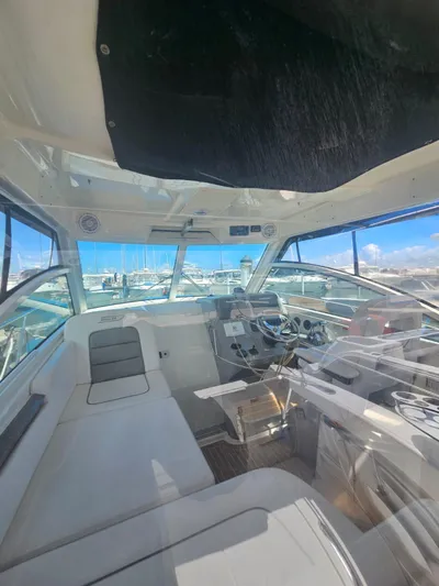  Yacht Photos Pics Interior view of 2013 Boston Whaler 315 Conquest boat with marina background.
