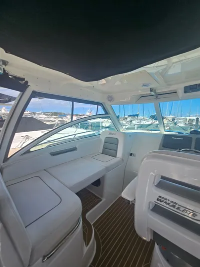  Yacht Photos Pics Interior of a 2013 Boston Whaler 315 Conquest boat with seating and helm.