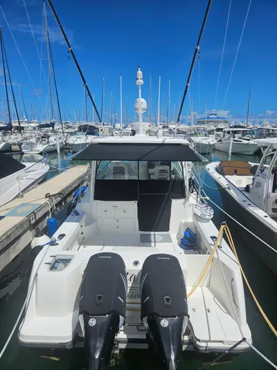  Yacht Photos Pics 2013 Boston Whaler 315 Conquest docked at a marina, featuring dual outboard engines.