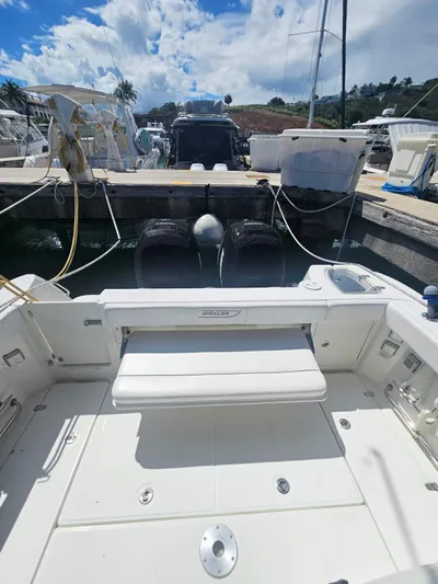  Yacht Photos Pics 2013 Boston Whaler 315 Conquest docked, showcasing spacious deck and dual engines.