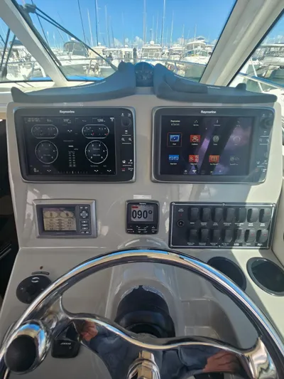  Yacht Photos Pics Control panel of 2013 Boston Whaler 315 Conquest with navigation screens and steering wheel.