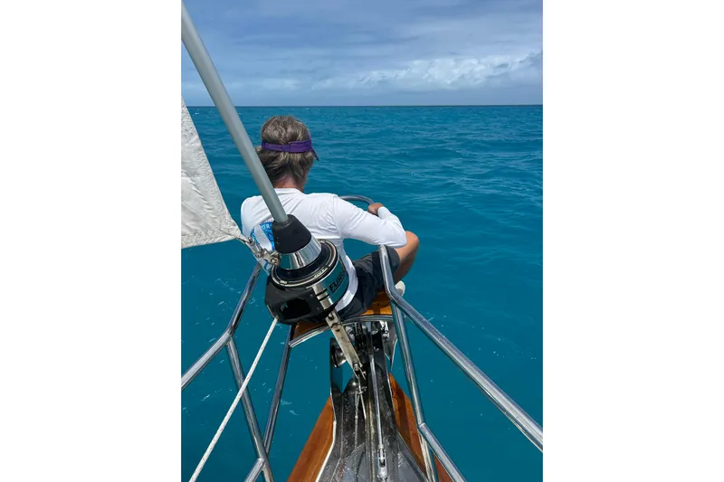 Sirius Yacht Photos Pics Person relaxing on a 2011 Passport 470 Center Cockpit sailboat, enjoying the ocean view.