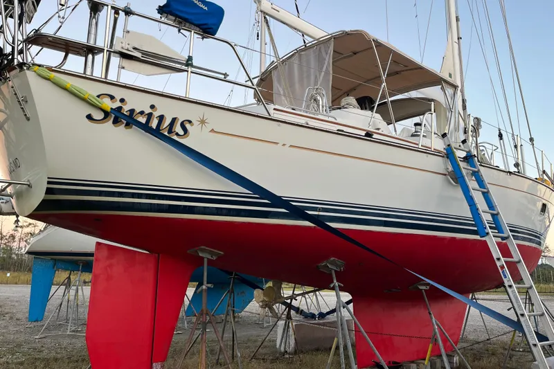 Sirius Yacht Photos Pics Sailboat "Sirius" on land, Passport 470 Center Cockpit, 2011 model, with red hull and blue ladder.
