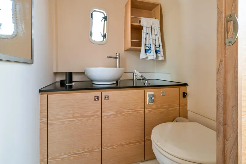  Yacht Photos Pics Modern bathroom in 2018 Fjord 36 Xpress yacht with sink, toilet, and storage.