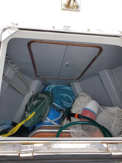 Sirius Yacht Photos Pics Storage compartment in 2011 Passport 470 Center Cockpit with nets and hoses.