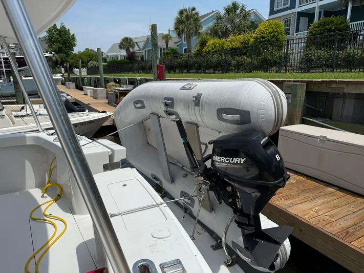  Yacht Photos Pics 2000 Mainship 390 Trawler with inflatable boat and Mercury outboard motor docked at marina.