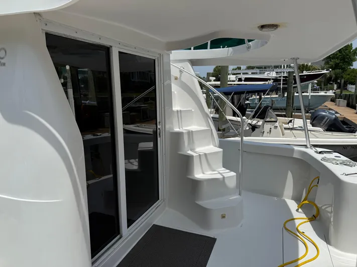  Yacht Photos Pics 2000 Mainship 390 Trawler deck with stairs, sliding doors, and marina view.