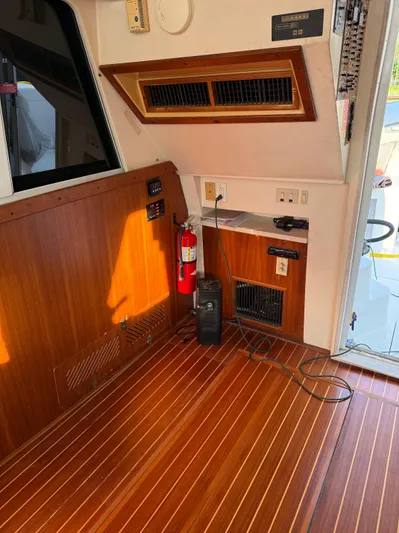  Yacht Photos Pics Interior of a 2000 Mainship 390 Trawler with wood paneling and safety equipment.