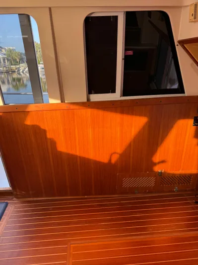  Yacht Photos Pics Interior of 2000 Mainship 390 Trawler with wooden paneling and sunlight streaming through windows.