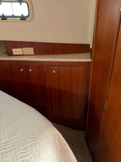  Yacht Photos Pics 2000 Mainship 390 Trawler cabin interior with wood cabinetry and bed.