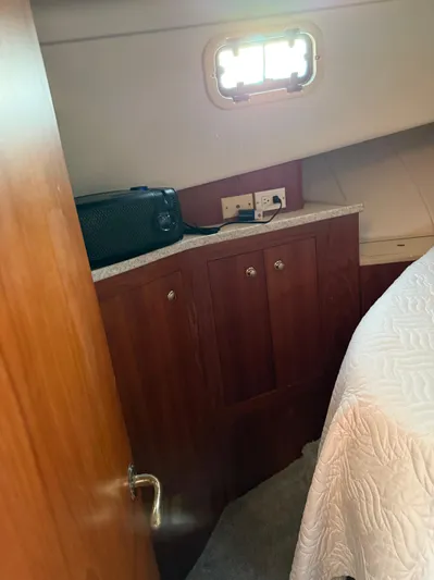  Yacht Photos Pics 2000 Mainship 390 Trawler cabin interior with wooden cabinetry and bed.