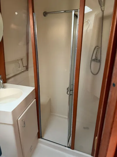  Yacht Photos Pics Bathroom interior of 2000 Mainship 390 Trawler with shower and sink.