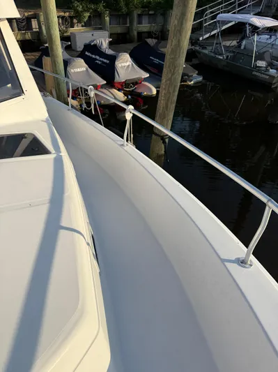  Yacht Photos Pics 2000 Mainship 390 Trawler docked, showcasing sleek deck and railing design.