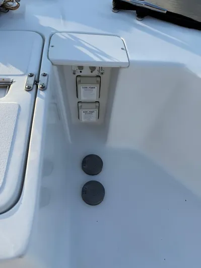  Yacht Photos Pics 2000 Mainship 390 Trawler deck with electrical outlets and storage compartment.