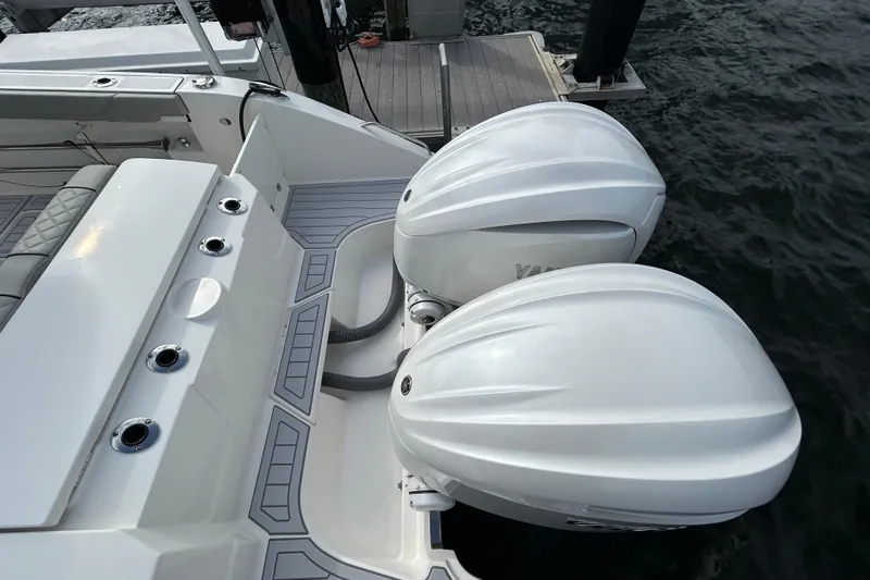  Yacht Photos Pics 2023 Pursuit S 288 Sport boat with dual outboard engines at dock.