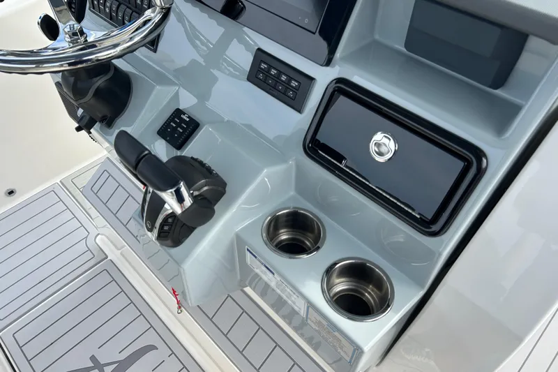  Yacht Photos Pics 2023 Pursuit S 288 Sport boat dashboard with steering wheel and controls.