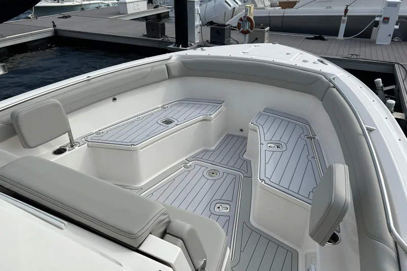  Yacht Photos Pics 2023 Pursuit S 288 Sport boat interior with sleek seating and storage compartments.