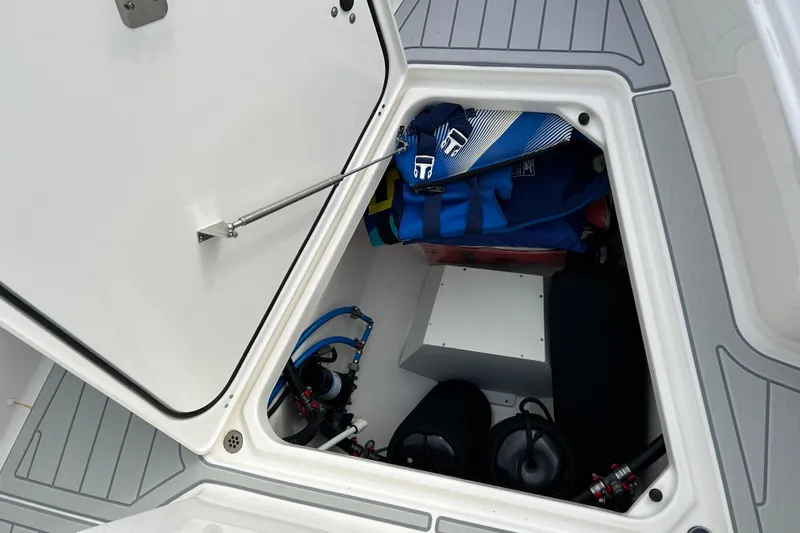  Yacht Photos Pics 2023 Pursuit S 288 Sport boat storage compartment with life jackets and equipment.