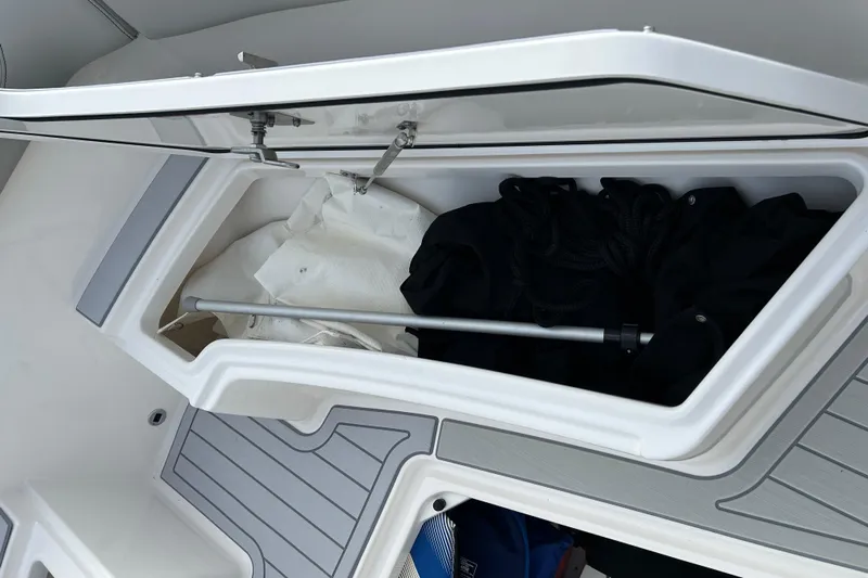  Yacht Photos Pics 2023 Pursuit S 288 Sport boat storage compartment with gear and equipment.