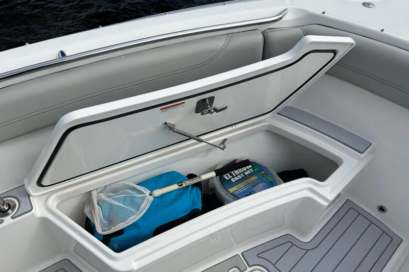  Yacht Photos Pics 2023 Pursuit S 288 Sport boat storage compartment with fishing gear and net.