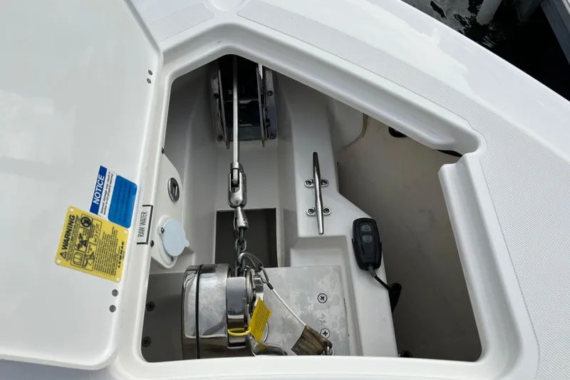  Yacht Photos Pics Anchor compartment of 2023 Pursuit S 288 Sport boat, featuring chain and winch.