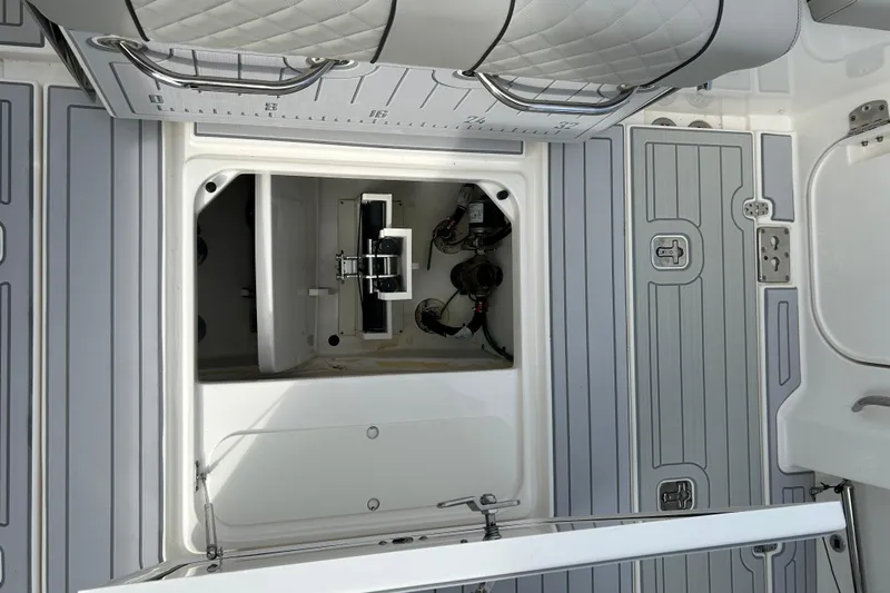 Yacht Photos Pics 2023 Pursuit S 288 Sport boat interior with open storage compartment and sleek design.