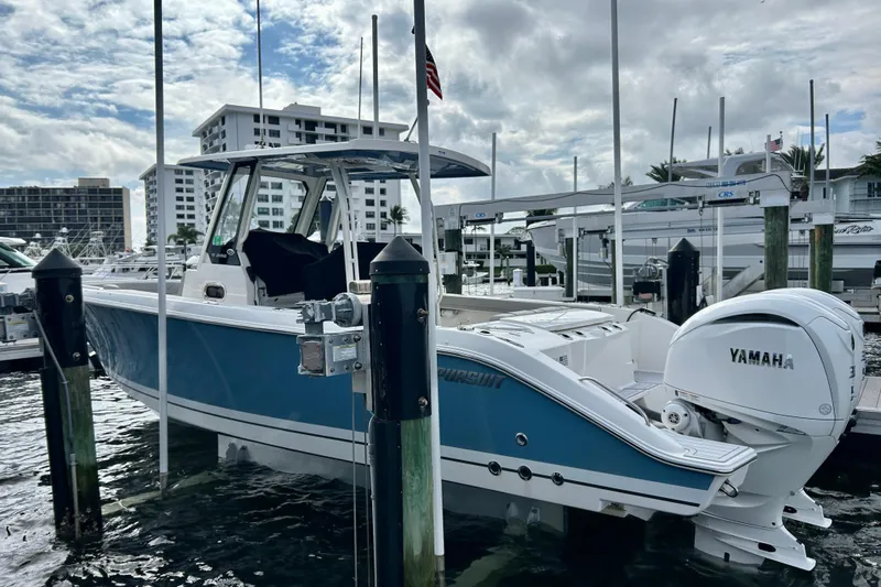  Yacht Photos Pics 2023 Pursuit S 288 Sport boat docked with Yamaha engines, under cloudy sky.
