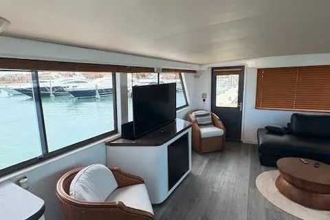 Island Yacht Photos Pics Interior of 1988 Hatteras 70 yacht with modern seating and large windows.