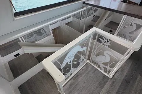 Island Yacht Photos Pics Interior of 1988 Hatteras 70 yacht with elegant etched glass stair railings.