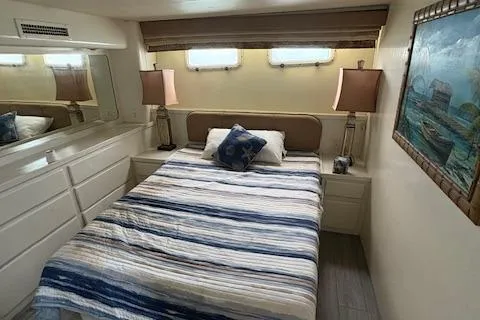 Island Yacht Photos Pics Cozy bedroom in 1988 Hatteras 70 yacht with striped bedding and nautical decor.