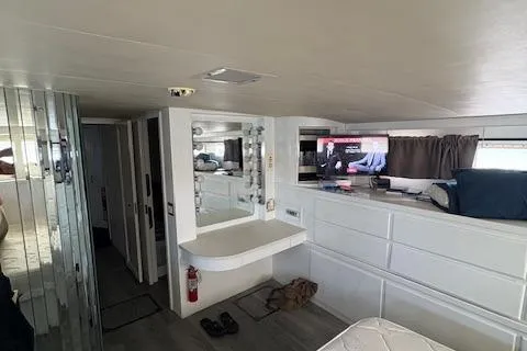 Island Yacht Photos Pics Interior of 1988 Hatteras 70 yacht with modern furnishings and a wall-mounted TV.