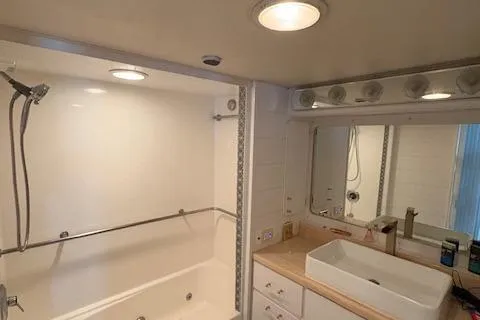 Island Yacht Photos Pics Bathroom interior of a 1988 Hatteras 70 yacht with modern fixtures and lighting.