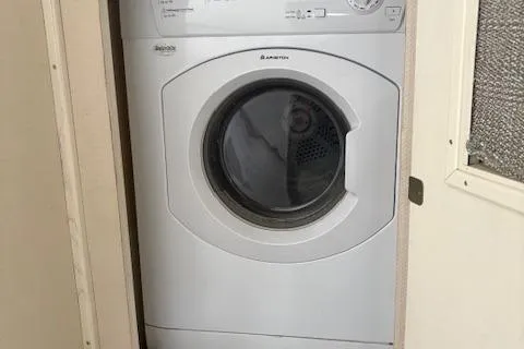 Island Yacht Photos Pics Washing machine inside 1988 Hatteras 70 yacht, compact and efficient design.