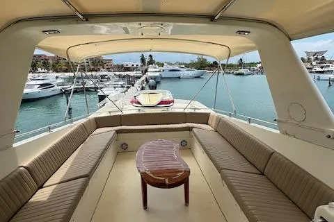 Island Yacht Photos Pics 1988 Hatteras 70 yacht interior with spacious seating and marina view.