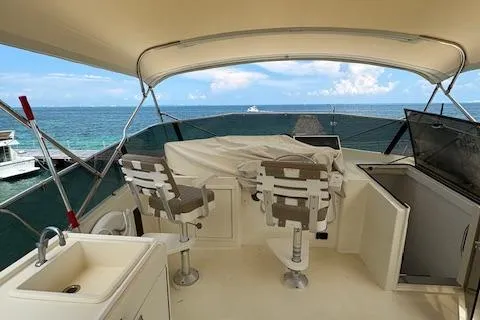 Island Yacht Photos Pics 1988 Hatteras 70 yacht deck with seating, sink, and ocean view.