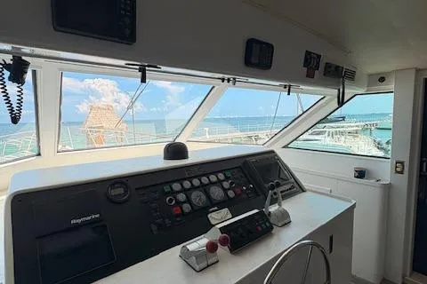 Island Yacht Photos Pics 1988 Hatteras 70 yacht helm with ocean view through large windows.