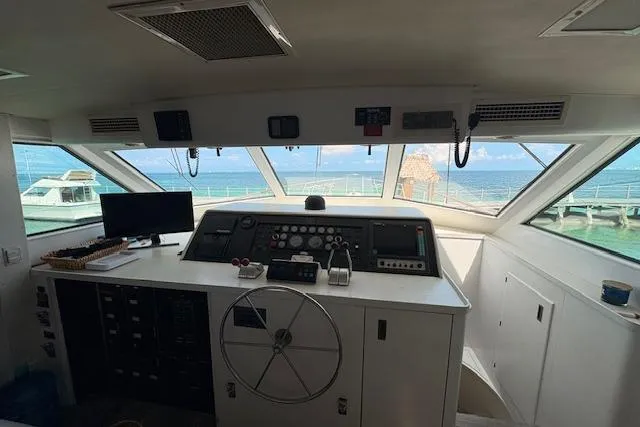 Island Yacht Photos Pics Interior view of 1988 Hatteras 70 yacht helm with ocean view.
