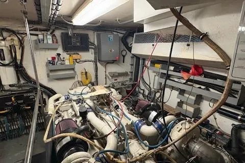 Island Yacht Photos Pics Engine room of a 1988 Hatteras 70 yacht, showcasing mechanical components and wiring.
