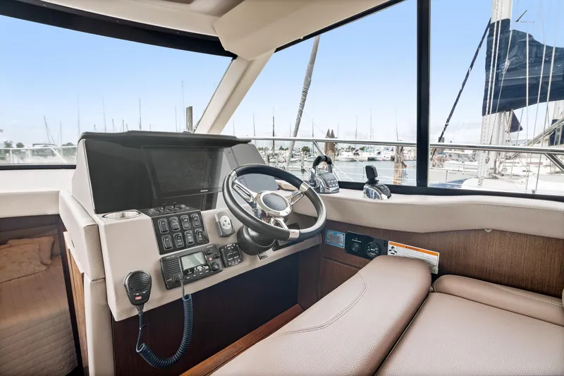 Hoff Yacht Photos Pics 2016 Regal 42 Grande Coupe helm with steering wheel and control panel.