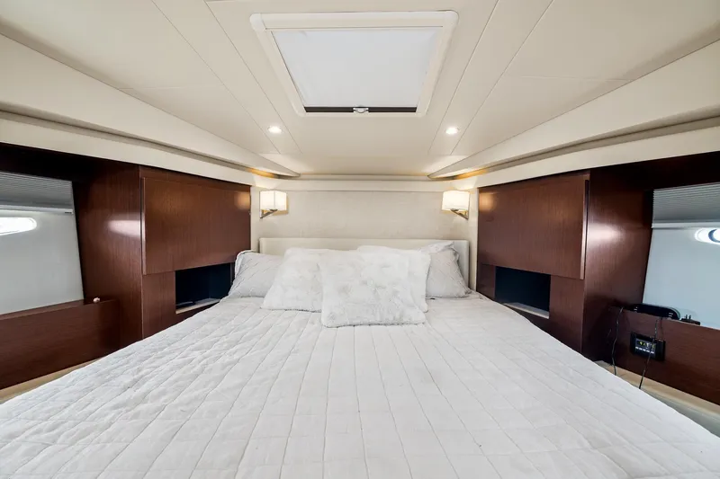 Hoff Yacht Photos Pics Luxurious bedroom interior of 2016 Regal 42 Grande Coupe yacht with elegant wood accents.