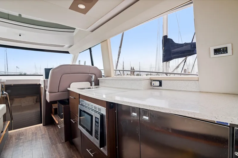 Hoff Yacht Photos Pics Luxurious interior of 2016 Regal 42 Grande Coupe yacht with modern kitchen amenities.