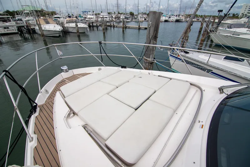 Hoff Yacht Photos Pics 2016 Regal 42 Grande Coupe yacht with sunbathing deck in marina setting.