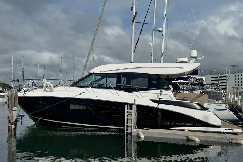 Hoff Yacht Photos Pics 2017 Regal 42 Grande Coupe yacht docked at marina under cloudy sky.