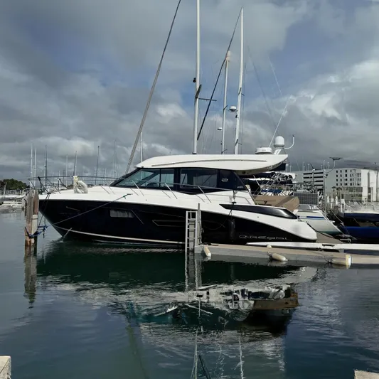 Hoff Yacht Photos Pics 2017 Regal 42 Grande Coupe yacht docked in a marina under cloudy skies.