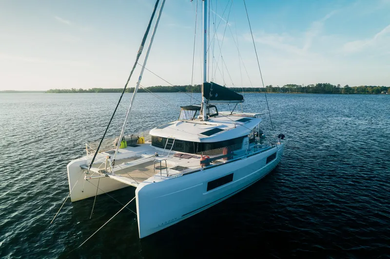 Cloud II Yacht Photos Pics 2023 Lagoon 40 catamaran sailing on calm waters under a clear blue sky.